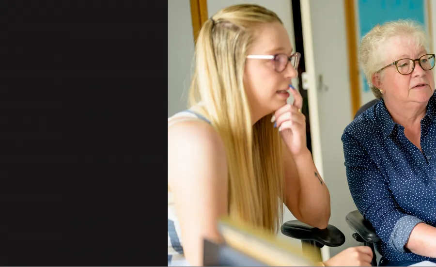 Two women looking at computer 